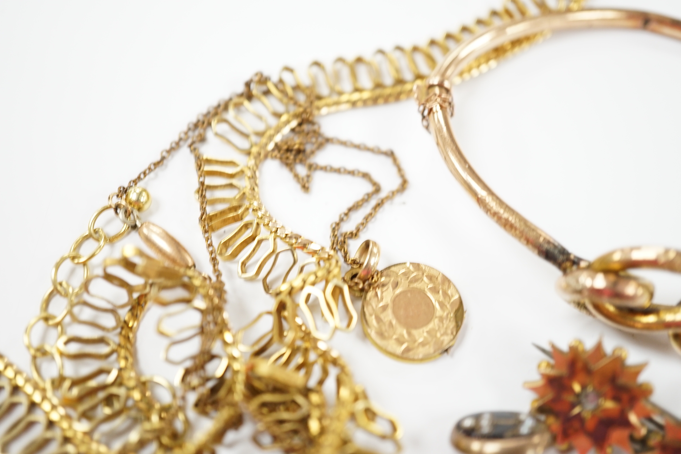 A 9ct. gold fringe necklace, 49cm(a.f.) a 9ct. gold bangle, 25.9 grams, a gold plated locket on a gold plated fine chain, a Victorian yellow metal and two stone diamond set brooch and a stick pin head.